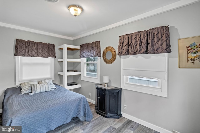 bedroom featuring wood finished floors and baseboards