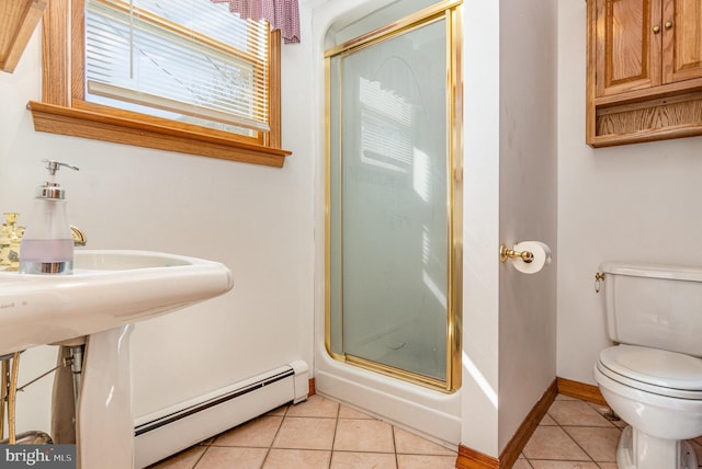 bathroom with a baseboard radiator, a shower stall, toilet, and tile patterned floors