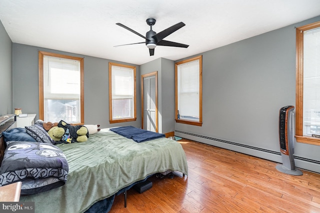 bedroom with a ceiling fan, light wood-type flooring, and a closet