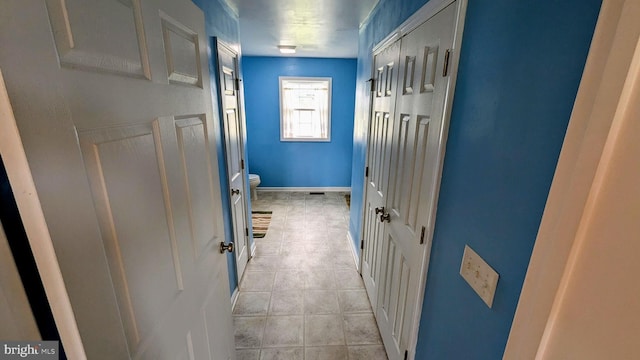 hallway featuring baseboards