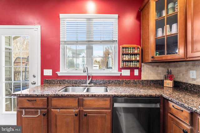 kitchen with a sink, tasteful backsplash, brown cabinetry, and stainless steel dishwasher