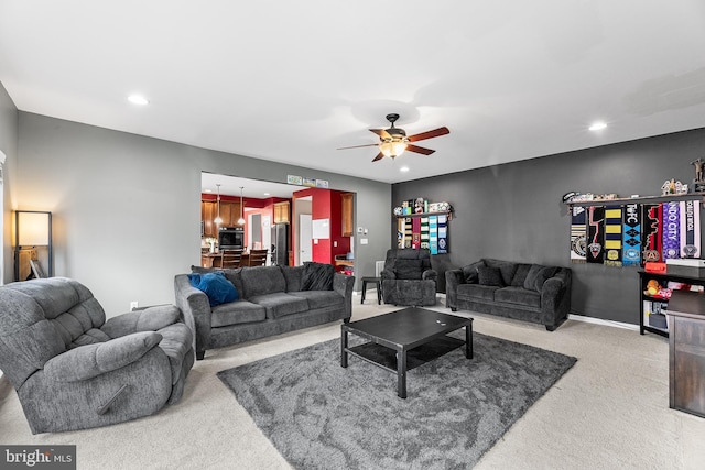 living area featuring recessed lighting, carpet flooring, a ceiling fan, and baseboards