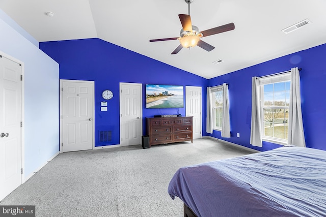 bedroom featuring carpet floors, visible vents, vaulted ceiling, and a ceiling fan