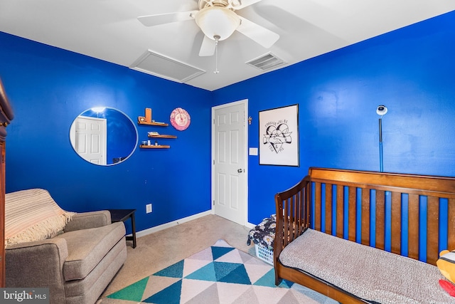 bedroom featuring a ceiling fan, baseboards, visible vents, carpet, and attic access