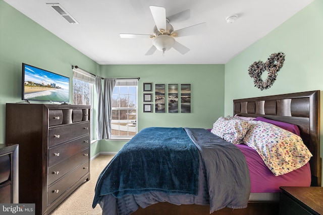 carpeted bedroom with ceiling fan, visible vents, and baseboards