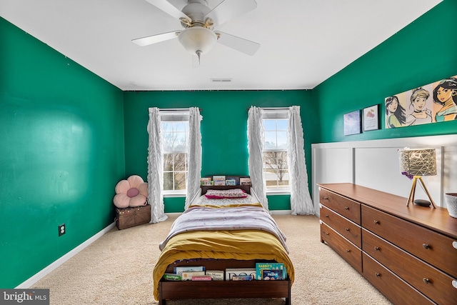 bedroom with a ceiling fan, carpet flooring, visible vents, and baseboards