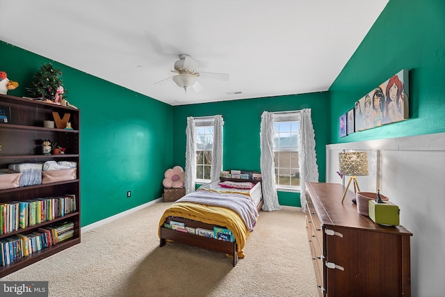 carpeted bedroom featuring a ceiling fan and baseboards