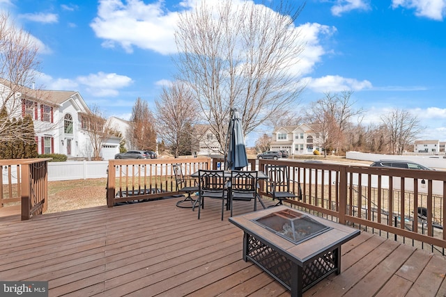 deck with an outdoor fire pit and a residential view