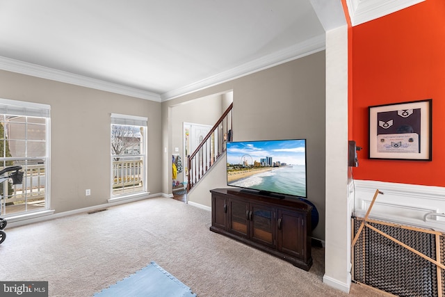 carpeted living room with visible vents, crown molding, stairway, and baseboards