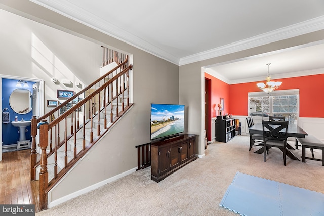 interior space featuring baseboards, stairway, crown molding, carpet flooring, and a notable chandelier