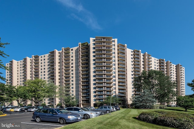 view of building exterior with uncovered parking