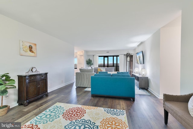 living room featuring baseboards and wood finished floors