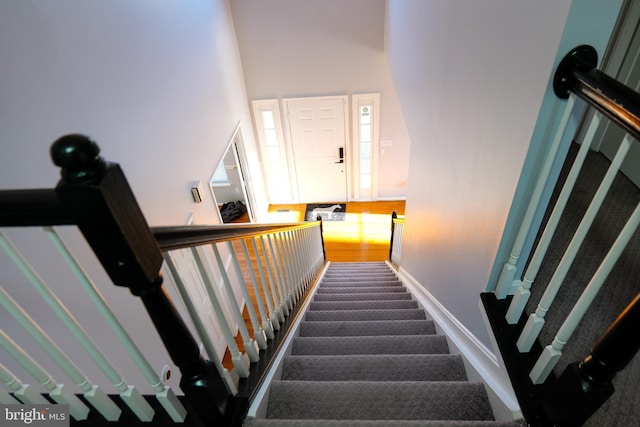 staircase featuring baseboards