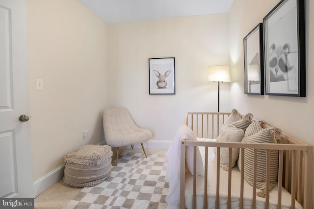 bedroom with a nursery area and baseboards