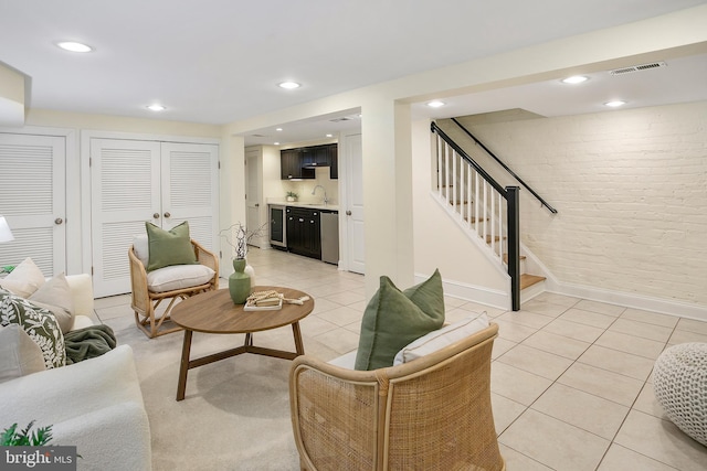 living room featuring indoor wet bar, visible vents, light tile patterned flooring, beverage cooler, and stairs