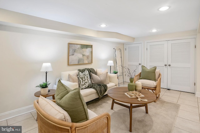 living area featuring recessed lighting, baseboards, and light tile patterned floors