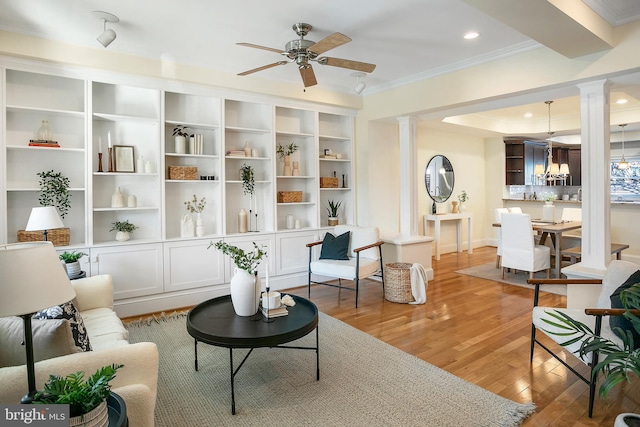 sitting room with light wood finished floors, a ceiling fan, ornamental molding, ornate columns, and recessed lighting