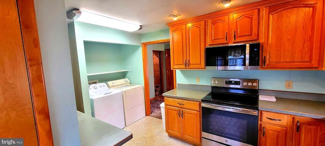 kitchen featuring light floors, appliances with stainless steel finishes, washer and clothes dryer, and brown cabinetry