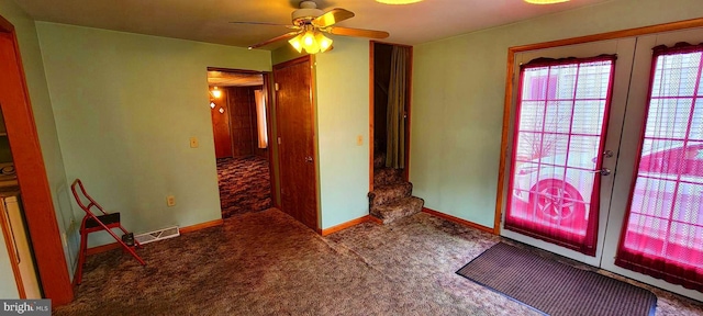 interior space featuring a ceiling fan, french doors, and baseboards