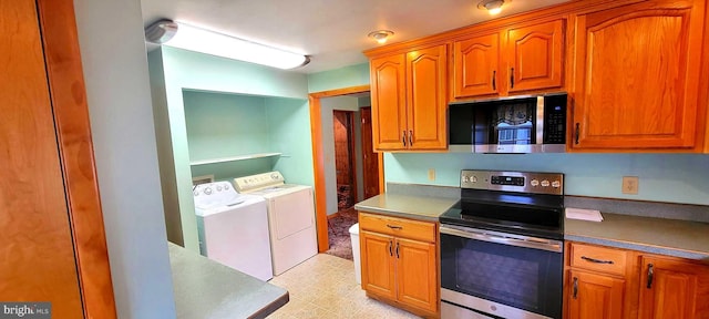 kitchen featuring brown cabinetry, stainless steel appliances, washer and dryer, and light floors