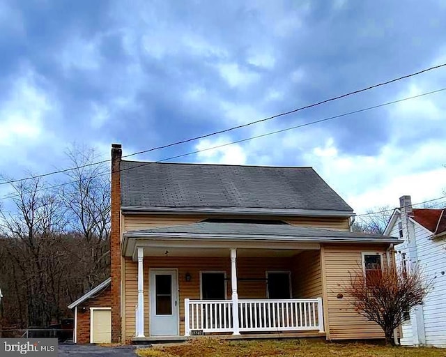 view of front of home featuring a porch and a chimney