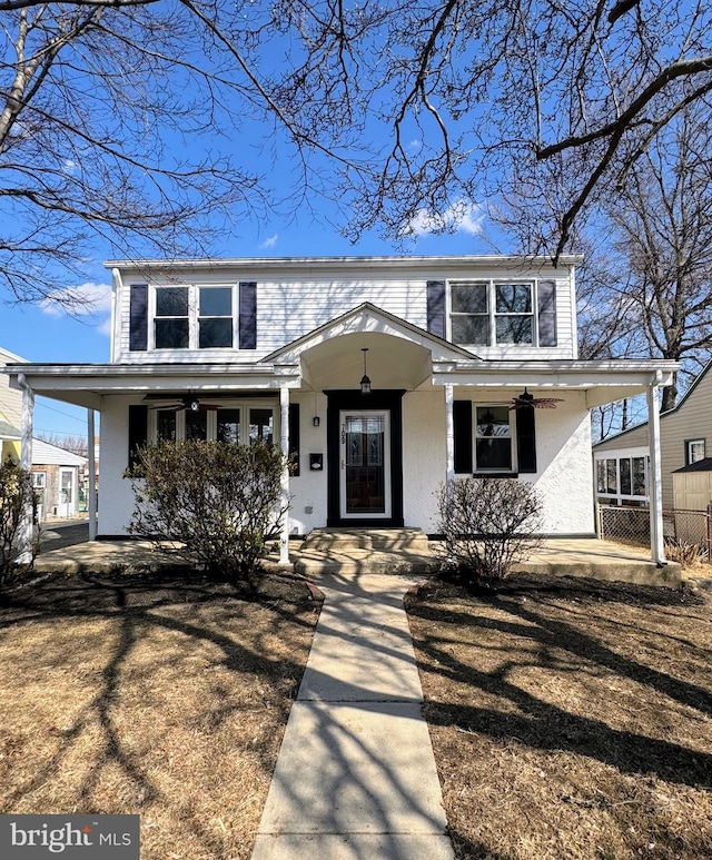 view of front of house featuring fence and a porch