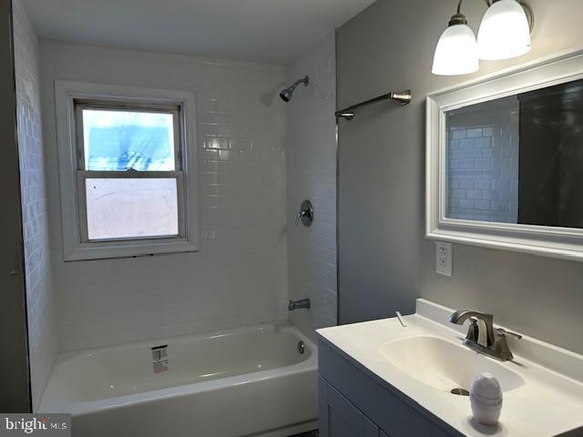 bathroom with tub / shower combination and vanity