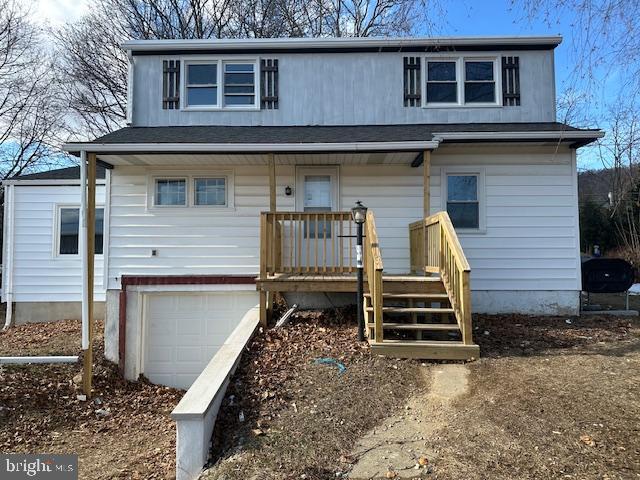 view of front of home with a garage and a porch