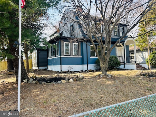 view of front of house with a porch and a chimney