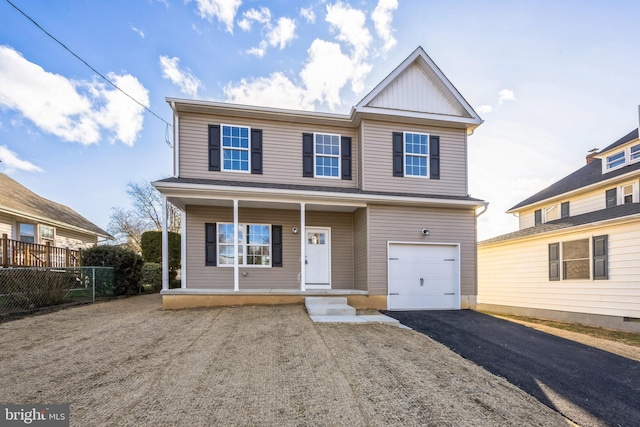 view of front of house with a porch, fence, an attached garage, and aphalt driveway