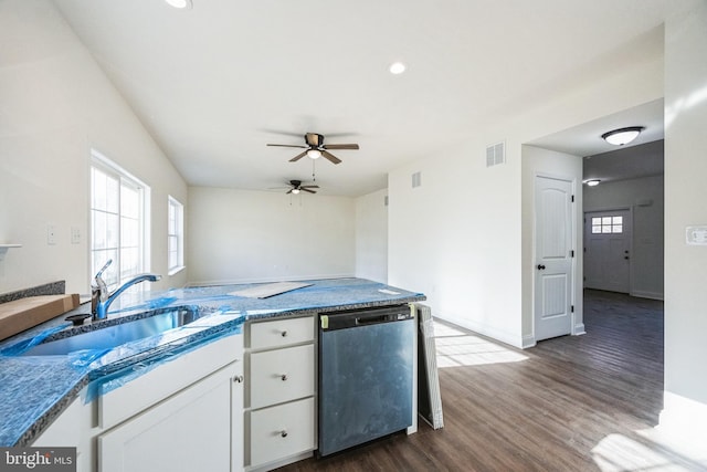 kitchen featuring visible vents, dishwasher, dark wood-style flooring, white cabinetry, and a sink