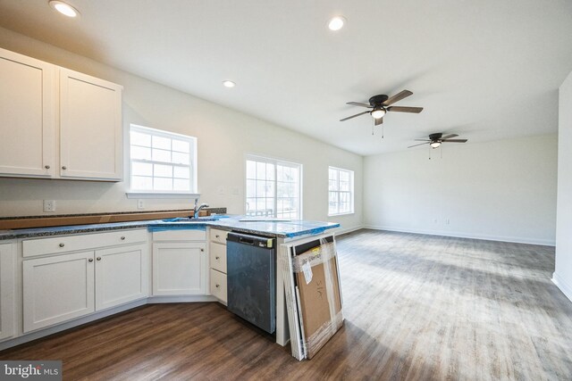 kitchen featuring dishwasher, dark wood-style floors, a peninsula, a sink, and recessed lighting