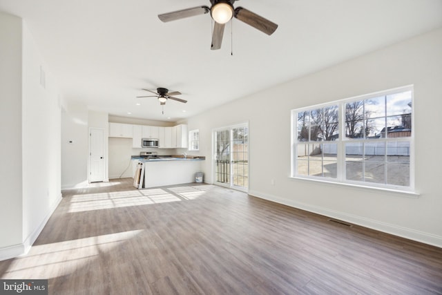 unfurnished living room with ceiling fan, light wood-style flooring, recessed lighting, visible vents, and baseboards