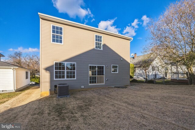 back of property featuring central AC and fence