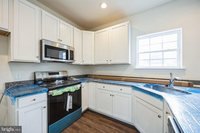 kitchen featuring white cabinetry, stainless steel appliances, and a sink