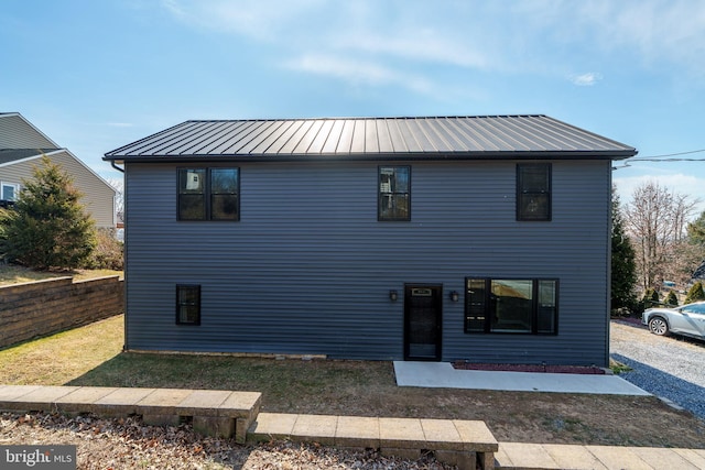 view of front of house featuring a standing seam roof and metal roof