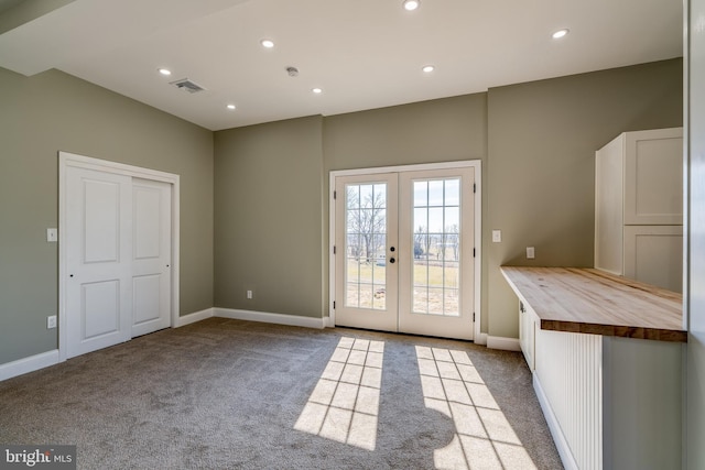 doorway with visible vents, baseboards, french doors, carpet floors, and recessed lighting