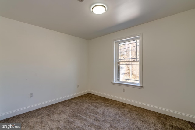 empty room with carpet flooring and baseboards