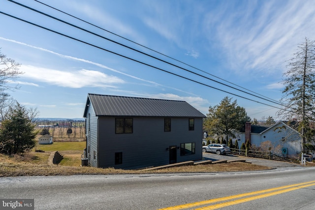 view of property exterior featuring metal roof