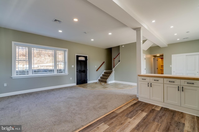 interior space with baseboards, open floor plan, wood finished floors, and recessed lighting