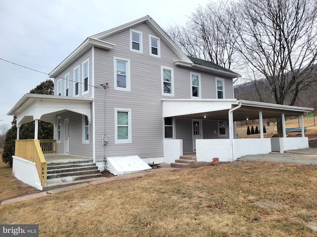 view of front facade with covered porch and a front lawn