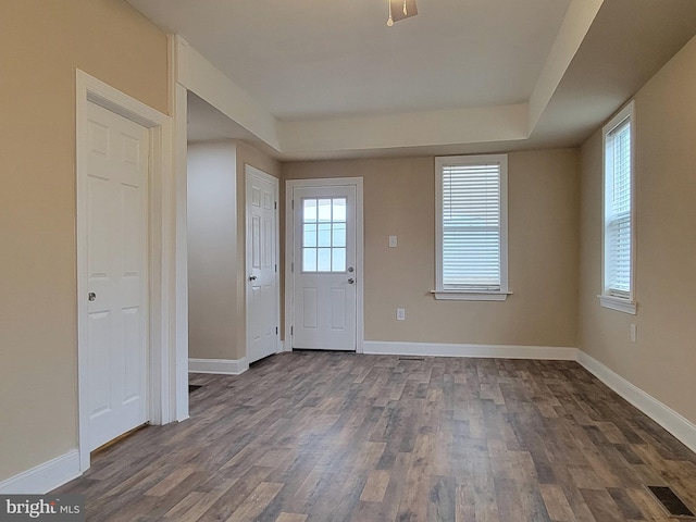 foyer entrance with dark wood-type flooring and baseboards