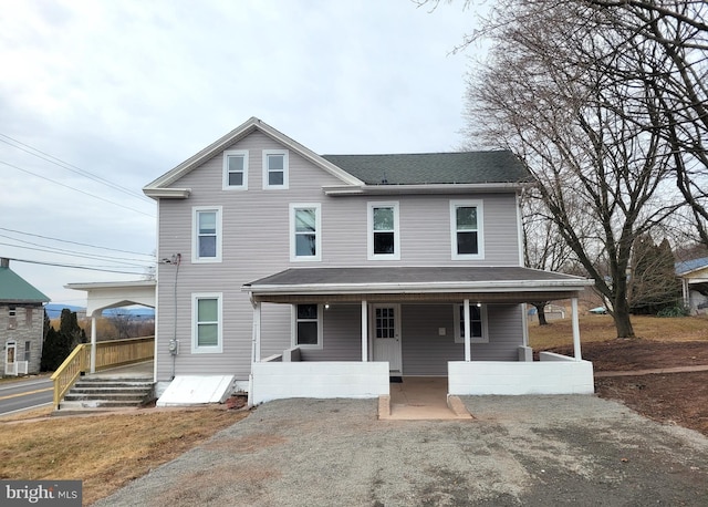 view of front of home with a porch and roof with shingles