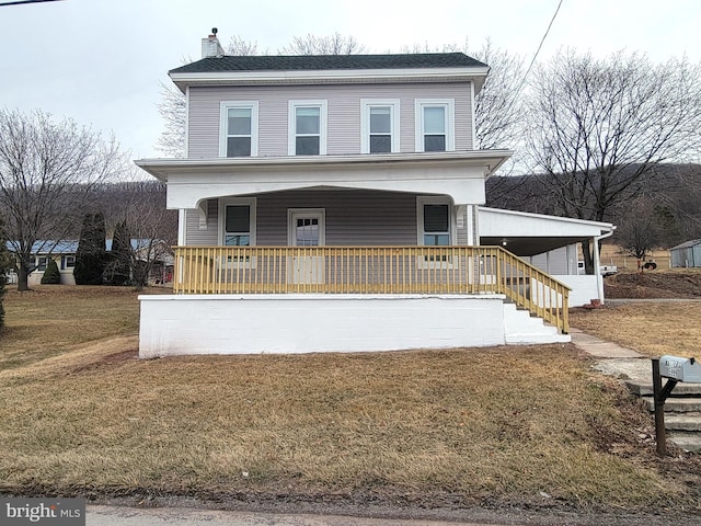 view of front of house with covered porch, a chimney, and a front lawn