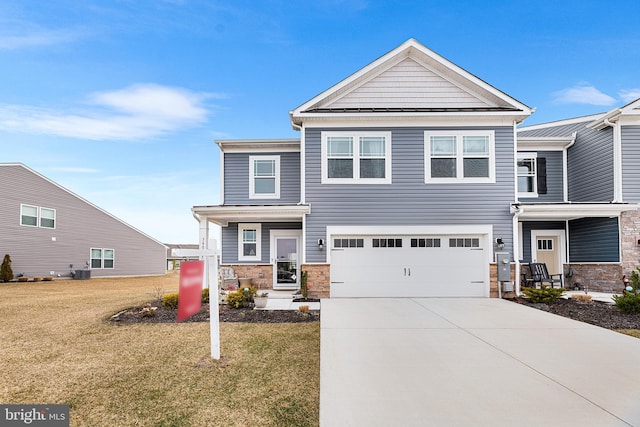 view of front of home with central AC unit, concrete driveway, stone siding, an attached garage, and a front lawn