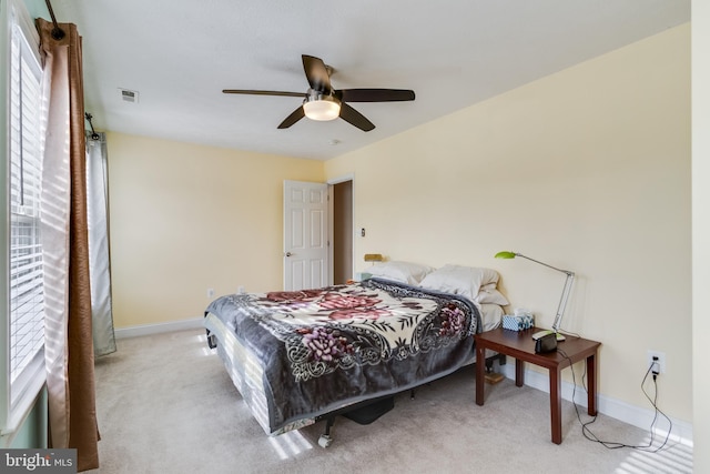 carpeted bedroom with baseboards, multiple windows, and visible vents