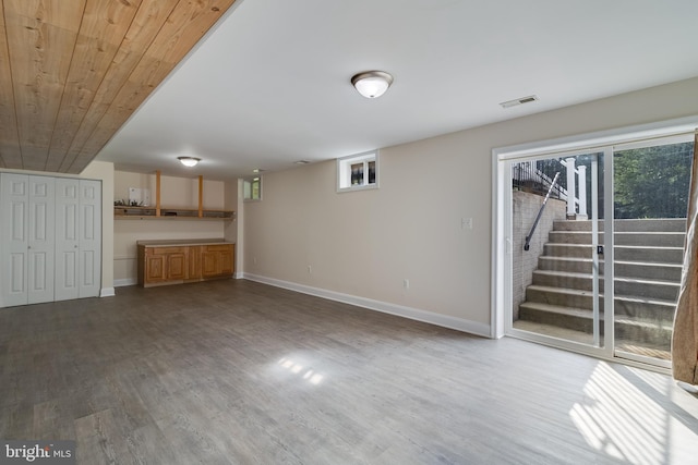 interior space featuring a wealth of natural light, baseboards, visible vents, and wood finished floors