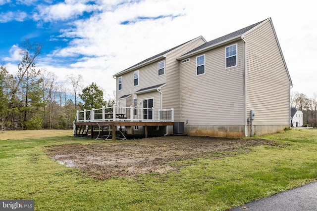 back of house featuring a deck, central AC, and a lawn