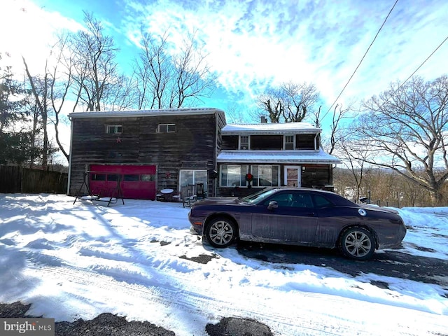 view of front facade featuring a garage and fence