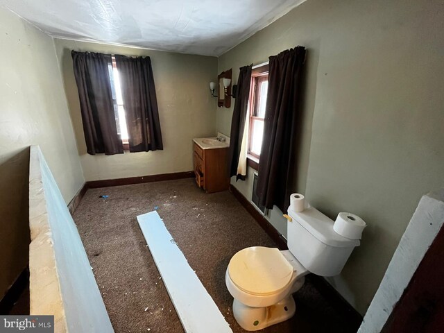 bathroom with toilet and baseboards